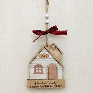 Detailed view of 2025 wooden house ornament with custom names and a buffalo plaid bow