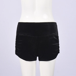 Detail view of black velvet high-waist shorts with elastic waist and ruched side details
