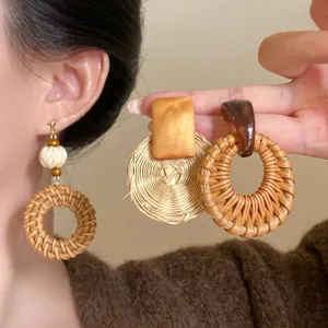 Bohemian fan-shaped raffia earrings with vintage steel pins and natural wood textures