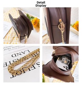 Detailed view of brown leather bag showing gold chain, metal zipper, and interior storage