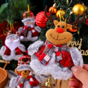 Close-up of reindeer plush ornament on a Christmas tree with festive holiday decorations