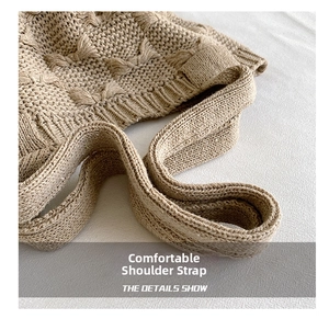 Detail of oat-colored knitted shoulder bag featuring 3D bow texture and wide strap