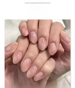 Detailed view of pink gradient oval press-on nails with fine glitter jelly finish