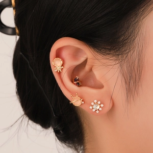 Dopamine style gold ear studs with pink cat eye stone and zircon astronaut designs