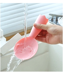 Close-up of pink tulip-shaped rice paddle being rinsed under water to show non-stick surface