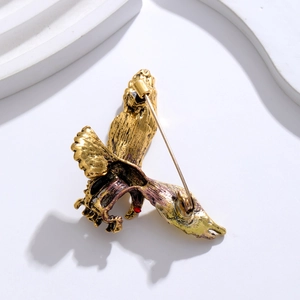 Vintage eagle brooch in gold finish with red stone detail and back pin structure