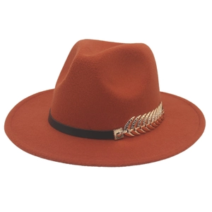 Detail of caramel wool felt fedora with black leather band and gold feather pin accent