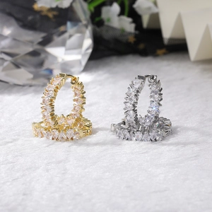 Detailed view of pear-cut AAA cubic zirconia hoop earrings in gold and silver finishes