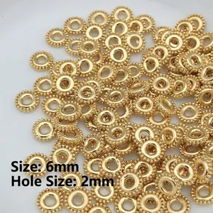 Detail of 6mm golden gear beads with 2mm hole for DIY jewelry making and necklaces