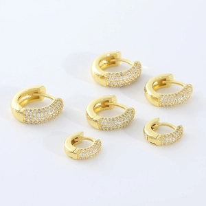 Three sizes of gold plated huggie hoops featuring pavé cubic zirconia settings