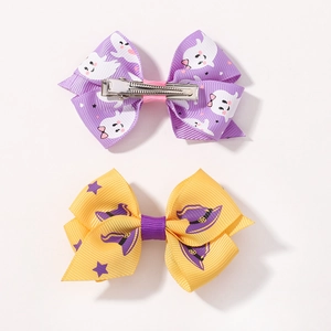 Detail of Halloween bow clips with ghost and wizard hat patterns on grosgrain ribbon