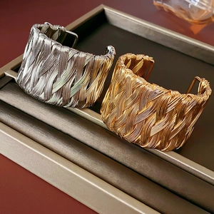 Detailed close-up of vintage twisted wire braided open bangles in gold and silver finish