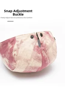 Detail of vintage pink tie-dye beret featuring adjustable metal snap buttons on back