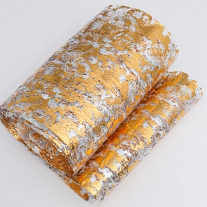 Close-up of gold and silver metallic foil texture on mesh table runner roll for weddings
