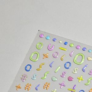 Macro shot of 3D jelly nail art stickers with colorful macaron letters and symbols