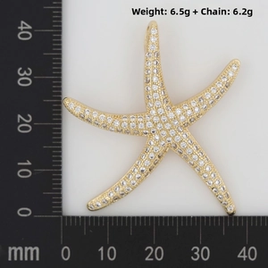 Macro shot of gold starfish pendant with white zircons showing 40mm size measurements