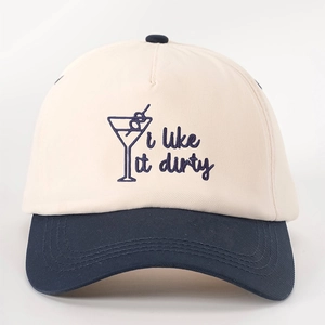 Detail of embroidered martini glass and 'i like it dirty' text on two-tone baseball cap