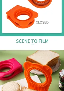 Détail d'un coupe-sandwich rond bicolore orange et rose avec un design d'oreilles d'ours