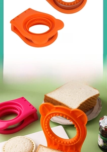 Detail of round sandwich cutter and sealer in orange and pink with bear ear design