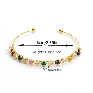 Detail view of gold zircon bracelet showing 6cm inner diameter and colorful gemstones