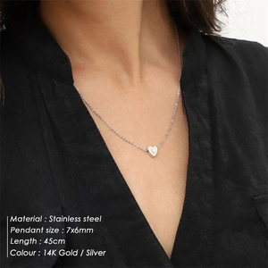 Minimalist heart pendant necklace in stainless steel with engraved letter L on model