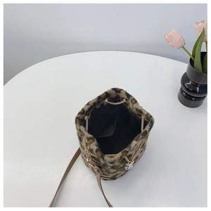 Top view of leopard print plush bucket bag showing interior space and pearl charm detail