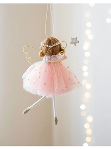 Detailed close-up of a pink fairy angel ornament with gold wings and star wand decor