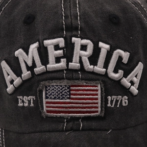 Detailed macro view of 3D America embroidery and US flag patch on washed baseball cap