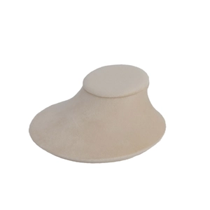 Macro shot of beige velvet necklace display stand with smooth curved neck profile