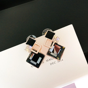 Detailed shot of geometric black zircon earrings with gold plating and cubic zirconia