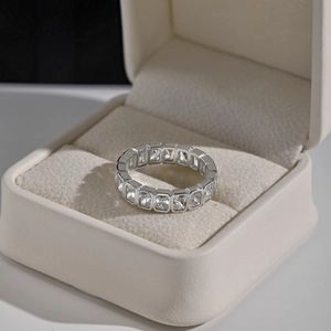 Macro shot of S925 sterling silver ring with rectangular zircons on white leather