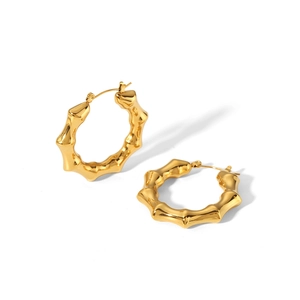 Detailed macro view of 18K gold plated stainless steel earrings with bamboo texture design