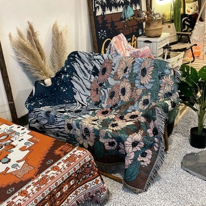 Bohemian woven sofa blanket with mountain and sunflower patterns and fringe edges