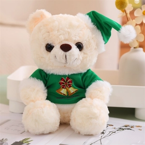 Detail of Christmas teddy bear in green Merry Christmas t-shirt and festive hat