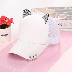 Detail of white baseball cap featuring rhinestone cat ears and metal rings on the brim