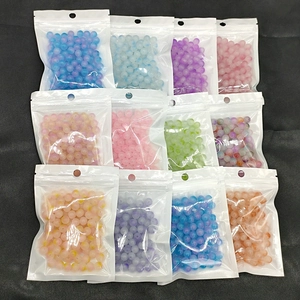 Detailed view of assorted 8mm gradient glass beads in organized transparent small bags
