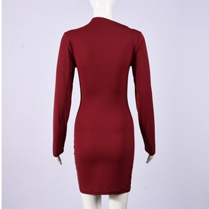 Detailed back view of a slim-fit dark red mini dress with long sleeves and elegant ruching