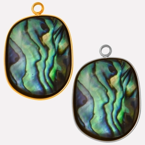 Detailed view of oval abalone shell pendants in gold and silver stainless steel frames