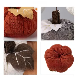 Detail of knitted pumpkin hanging ornaments with fine fabric texture and embroidery