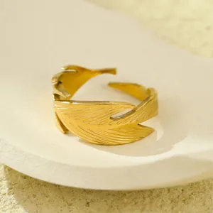 Detailed close-up of 18K gold leaf ring showing intricate leaf veins on textured tray