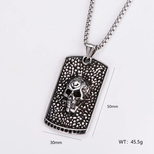 Macro shot of stainless steel rectangular pendant with skull relief and size dimensions