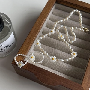 French style pearl jewelry set with daisy necklace and rings in a wooden jewelry box