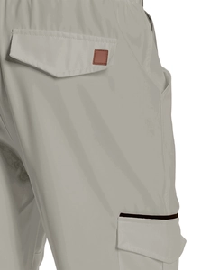 Detail of cargo pants showing the back pocket flap with a brown leather patch and stitching