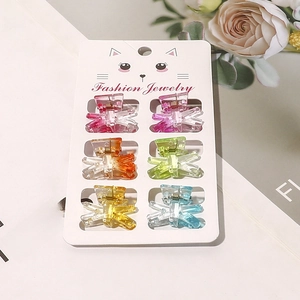 Detailed set of six colorful mini hair claws on a stylish fashion jewelry display card