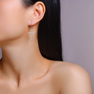 Macro view of sterling silver cross earrings with shimmering zircon pave setting