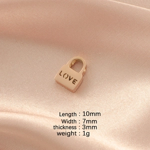 Rose gold hollow Love lock bead made of stainless steel on pink silk background