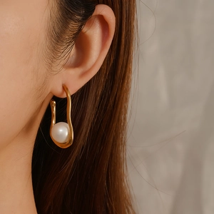 Elegant 18K gold plated oval hoop earrings with large white pearl on model