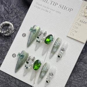Handmade emerald green Christmas press-on nails with 3D bows, rhinestones and snowflakes