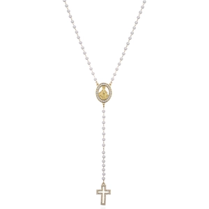 Detailed macro of a 18K gold plated Virgin Mary pendant with a zircon-set cross and pearls