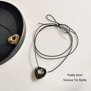 Hollow heart pendant necklace with black wax cord in gold and silver stainless steel